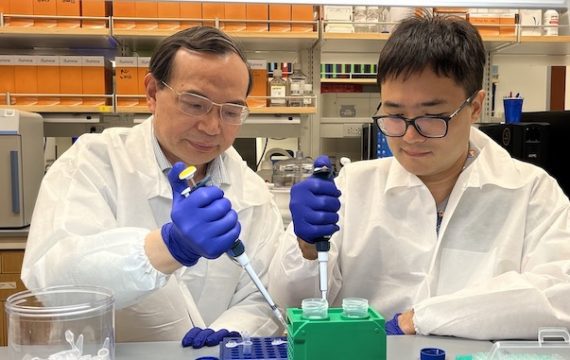 Professor and student in a lab holding instruments